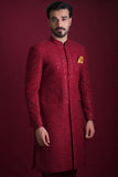 Arsalan Iqbal luxury crimson red sherwani featuring dense tonal floral embroidery, silver sequin accents, and a mustard yellow silk pocket square.