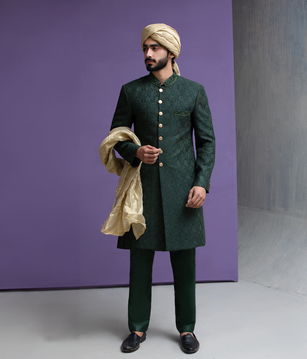 Arsalan Iqbal designer forest green embroidered sherwani for men, styled with a beige turban and matching silk dupatta for a wedding look.