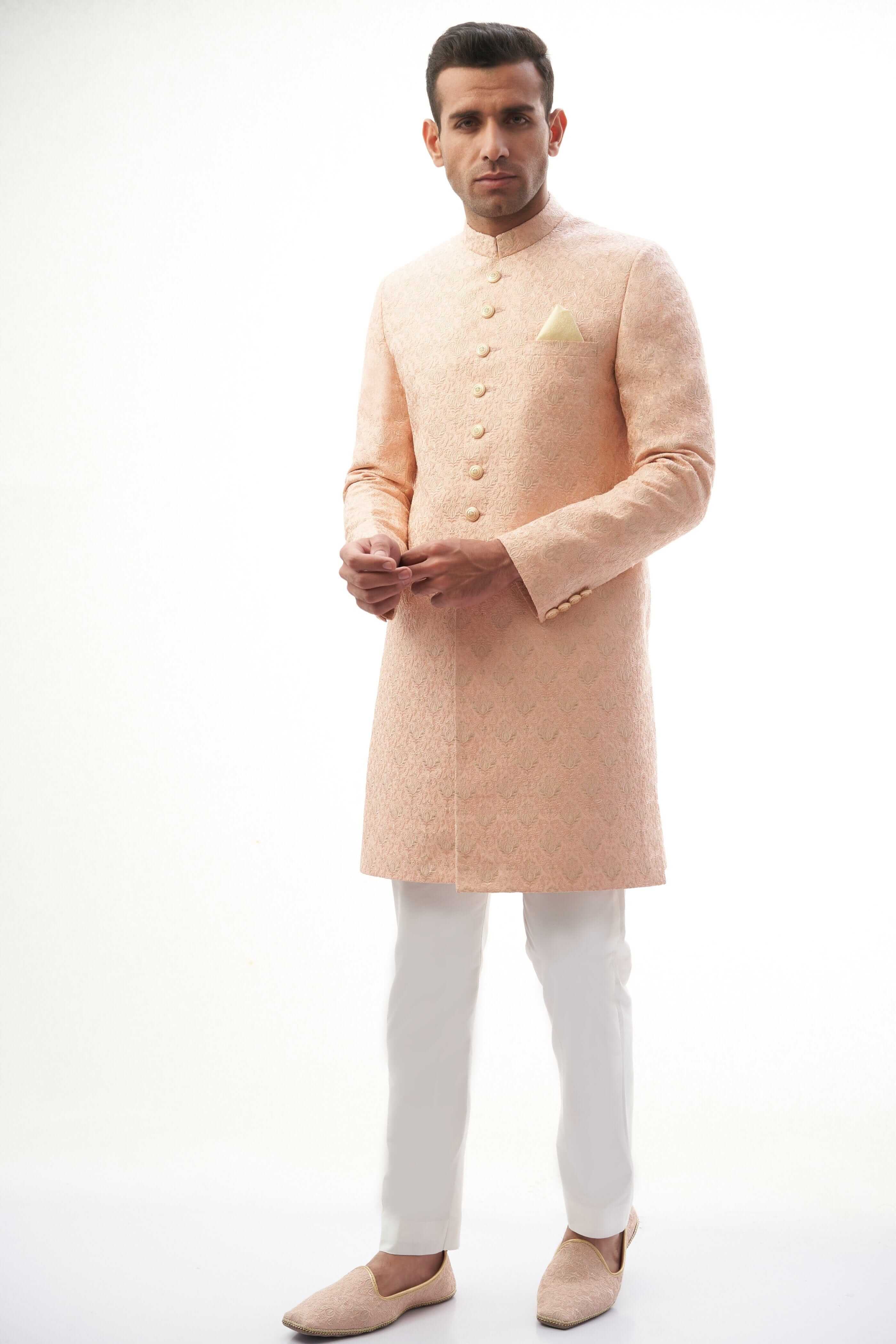 Peach Rawsilk Sherwani with All-Over Intricate Embroidery, Perfect for Traditional and Wedding Occasions.