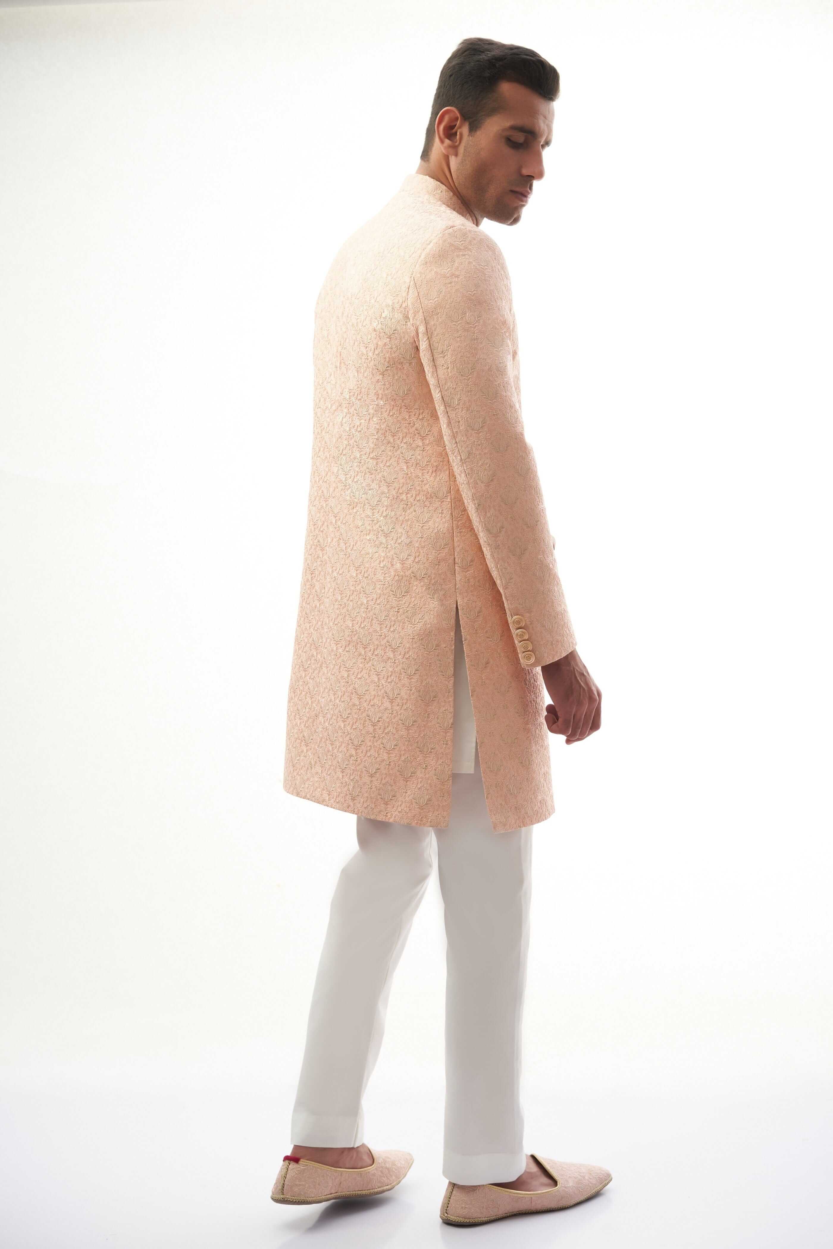 Peach Rawsilk Sherwani with All-Over Intricate Embroidery, Perfect for Traditional and Wedding Occasions.