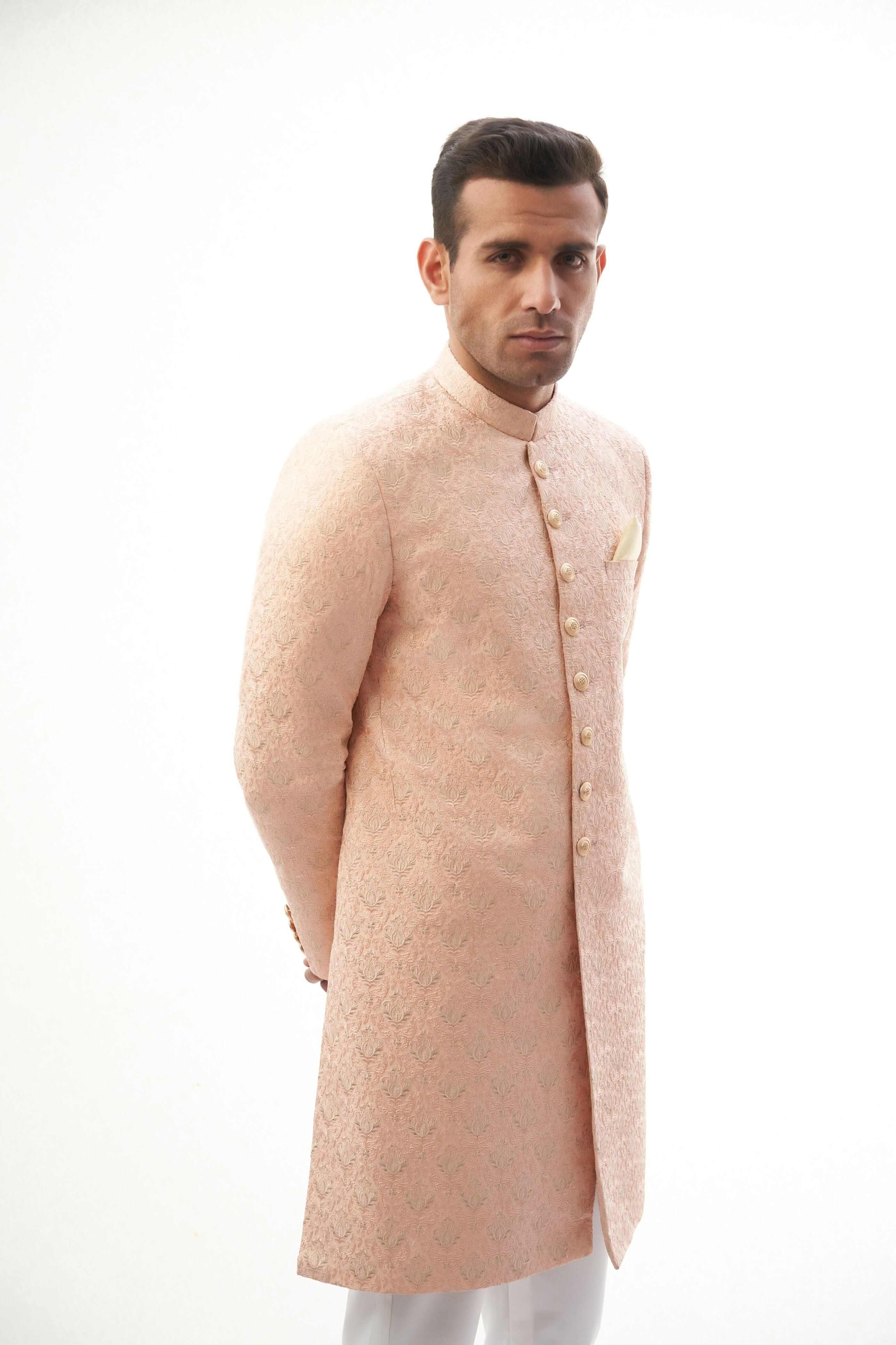 Peach Rawsilk Sherwani with All-Over Intricate Embroidery, Perfect for Traditional and Wedding Occasions.