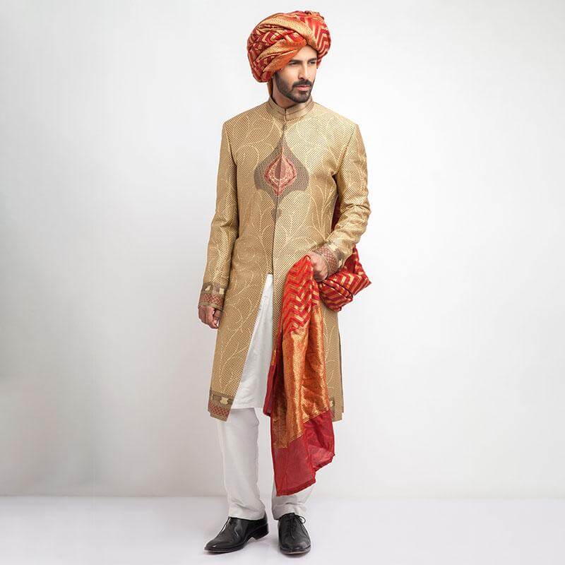 Antique gold, grey, and red brocade sherwani with a form-fitted cut, featuring intricate patterns and rich detailing for a regal appearance.