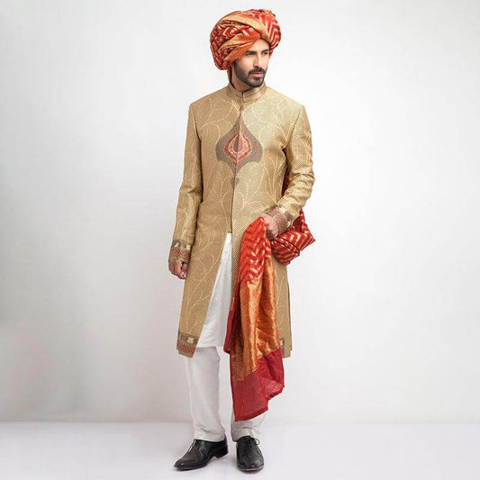 Antique gold, grey, and red brocade sherwani with a form-fitted cut, featuring intricate patterns and rich detailing for a regal appearance.
