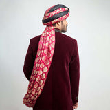 Back view of an Arsalan Iqbal maroon velvet sherwani showing the elegant drape of a pink and gold brocade turban.