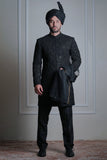 Male model wearing a black embroidered sherwani with turban by Arsalan Iqbal, luxury groom and wedding menswear