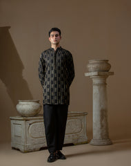 Man wearing Arsalan Iqbal's Black Kurta with allover gold metallic embroidery, styled with sunglasses and a silver watch against a dark background