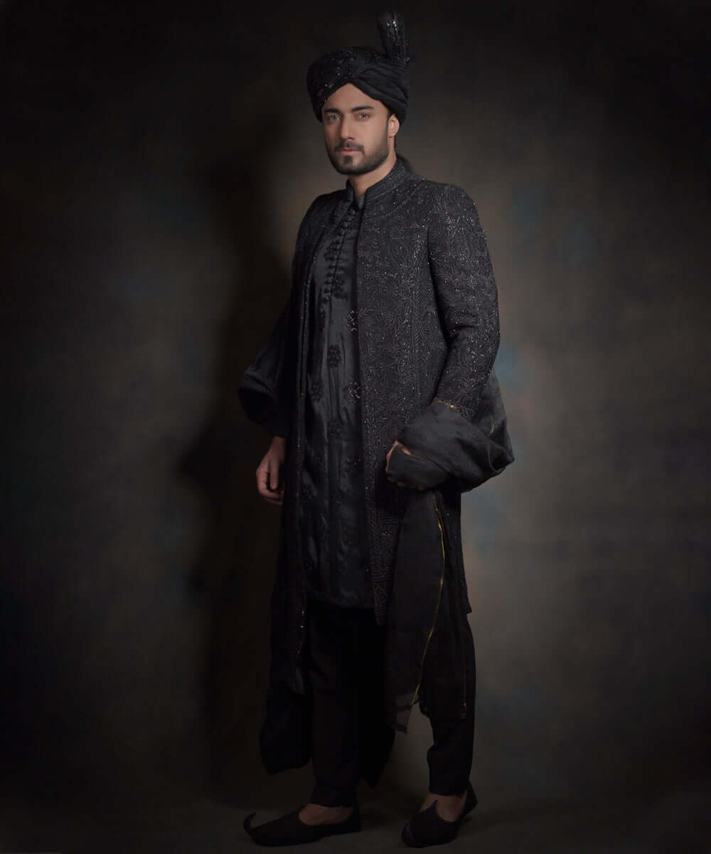 Midnight black sherwani with tonal embroidery and turban.