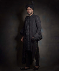 Midnight black sherwani with tonal embroidery and turban.