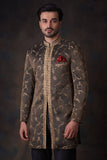 Arsalan Iqbal bronze-olive sherwani with gold ivy tilla embroidery, featuring a leaf-patterned mandarin collar and a crimson red pocket square.