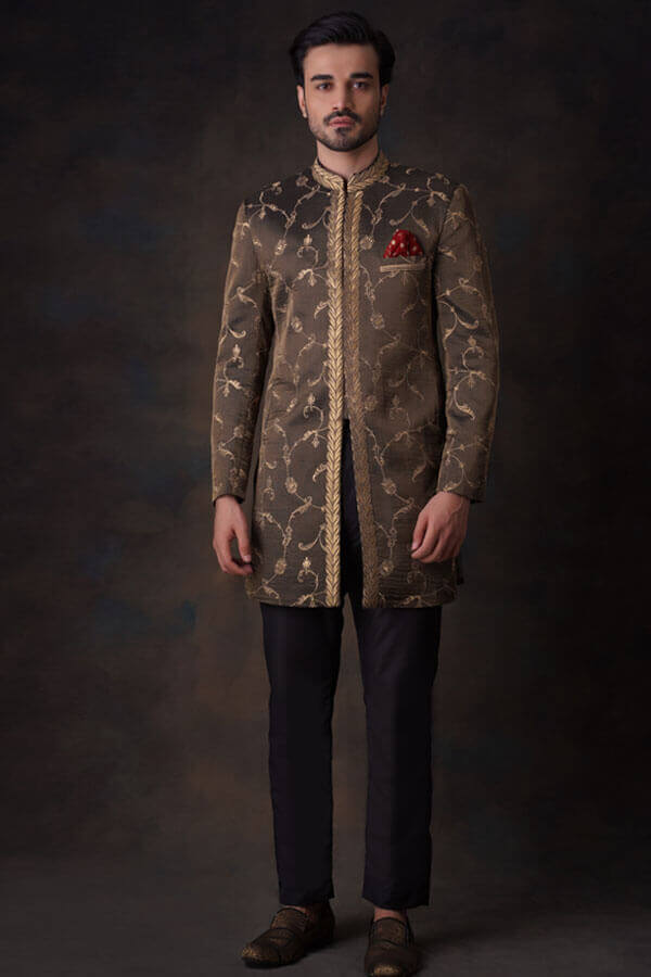 Arsalan Iqbal luxury bronze-olive sherwani featuring gold ivy vine embroidery, a leaf-patterned placket, and matching bronze-gold loafers.