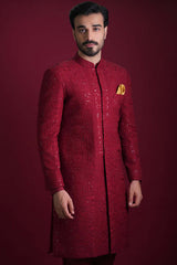 Arsalan Iqbal luxury crimson red sherwani featuring dense tonal floral embroidery, silver sequin accents, and a mustard yellow silk pocket square.