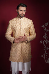 Arsalan Iqbal champagne gold prince coat with damask floral tilla embroidery, featuring a mandarin collar and gold-toned buttons, worn over a white tunic.