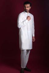 Full-length side view of Arsalan Iqbal luxury ivory silk kurta-pyjama featuring a mandarin collar and concealed placket, paired with straight-cut white trousers and dark formal loafers.