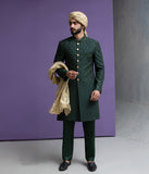 Arsalan Iqbal designer forest green embroidered sherwani for men, styled with a beige turban and matching silk dupatta for a wedding look.