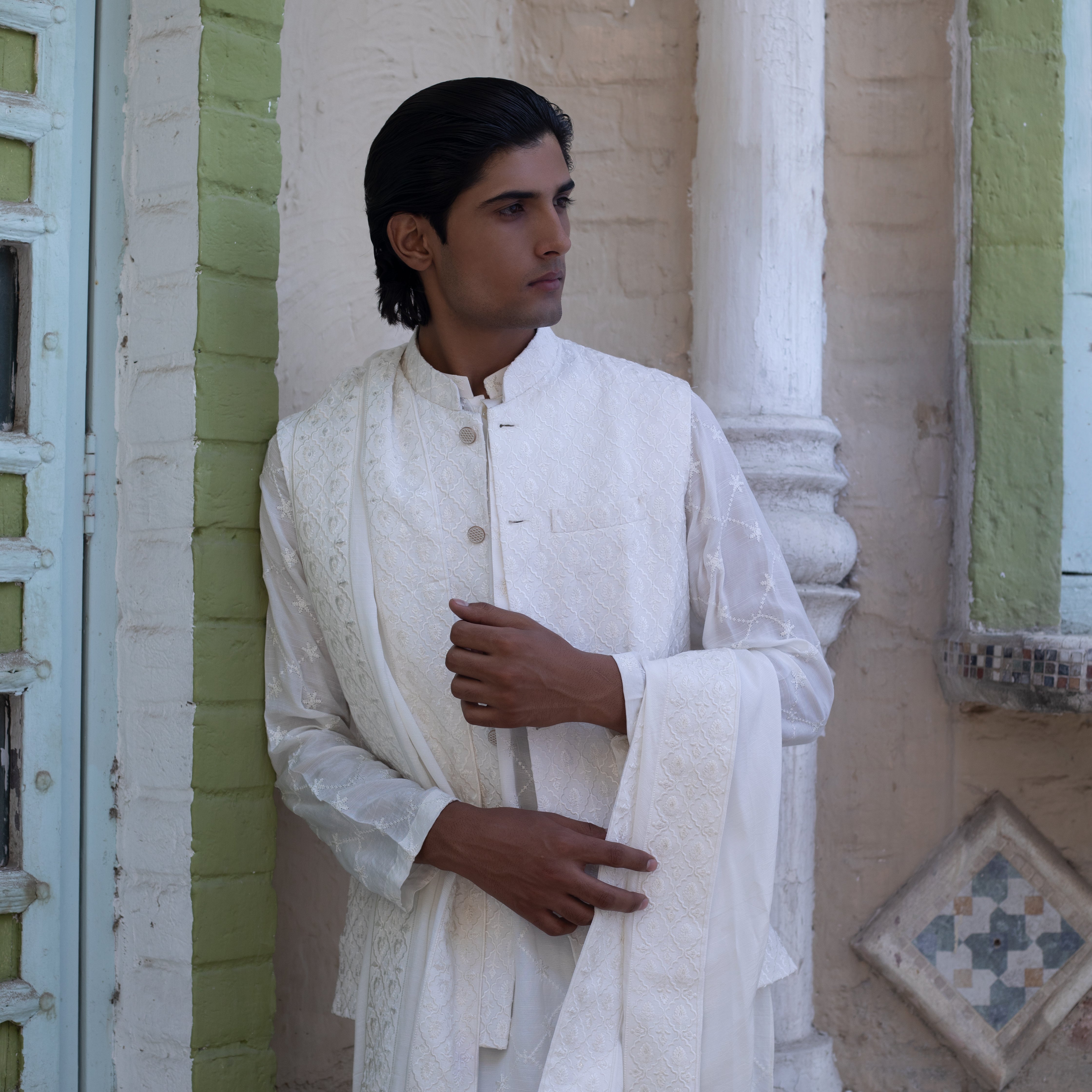 Arsalan Iqbal Nukta-e-Nazar Upper Body Close Up Side Gaze White Embroidered Waistcoat Kurta Set with Shawl for Men