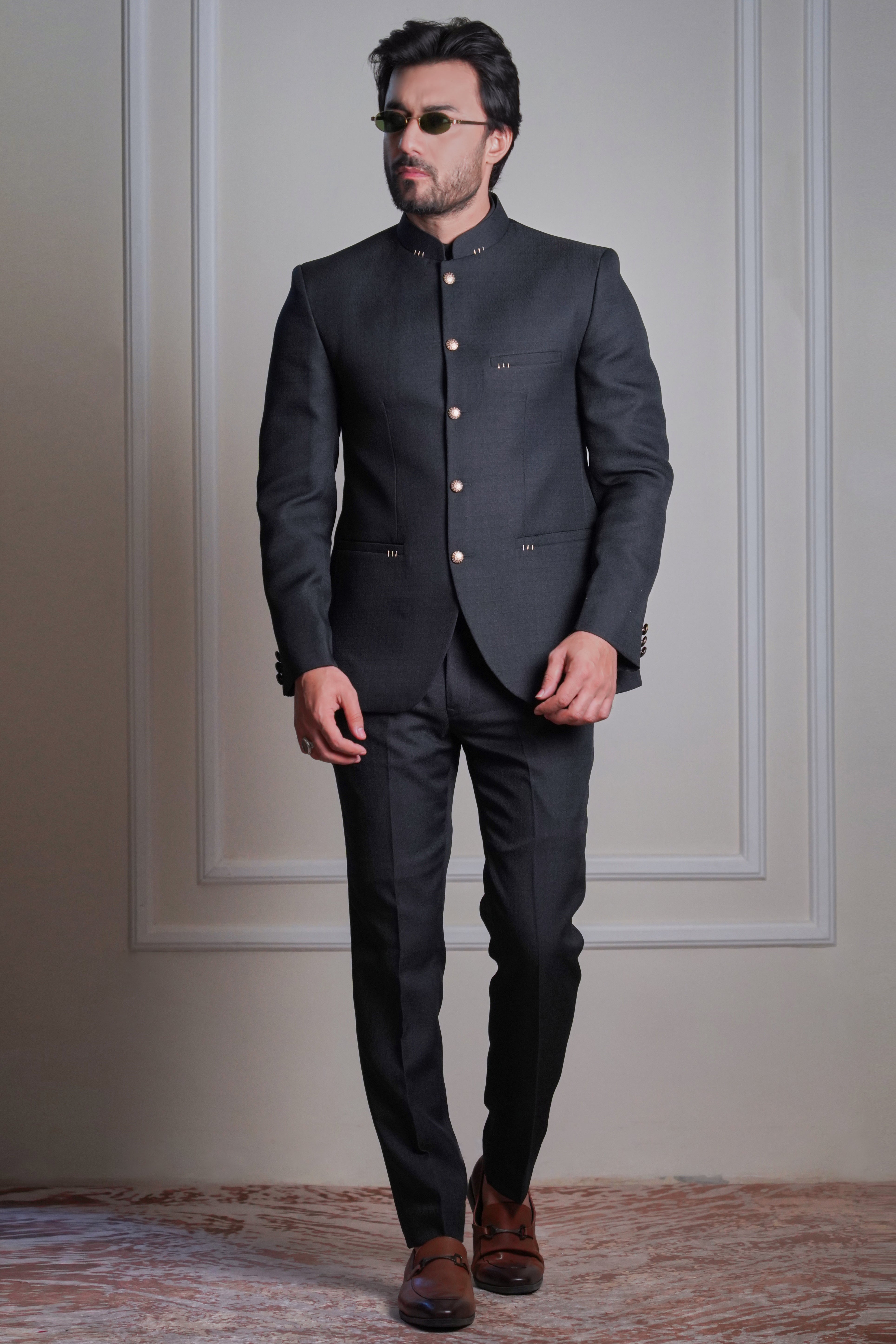 Men’s black handcrafted 3-piece suit with structured jacket, gold buttons, and tailored wool-silk blend  formal designer look by Arsalan Iqbal.