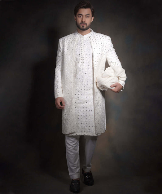 Arsalan Iqbal snow white luxury sherwani for men, featuring intricate geometric mirror-work and embroidery, styled with a matching white kurta, formal trousers, and black loafers.