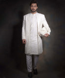 Arsalan Iqbal snow white luxury sherwani for men, featuring intricate geometric mirror-work and embroidery, styled with a matching white kurta, formal trousers, and black loafers.