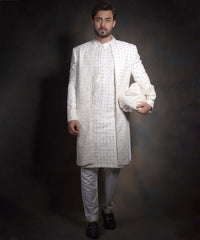 Arsalan Iqbal snow white luxury sherwani for men, featuring intricate geometric mirror-work and embroidery, styled with a matching white kurta, formal trousers, and black loafers.