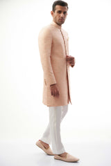 Peach Rawsilk Sherwani with All-Over Intricate Embroidery, Perfect for Traditional and Wedding Occasions.
