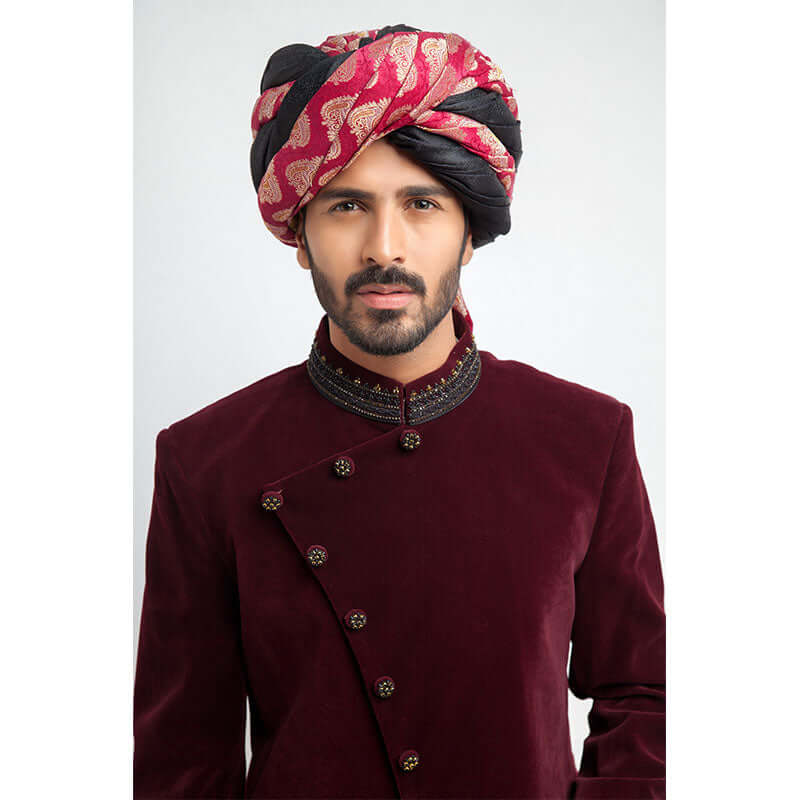Close-up of Arsalan Iqbal maroon velvet sherwani with embroidered collar and pink paisley patterned turban.