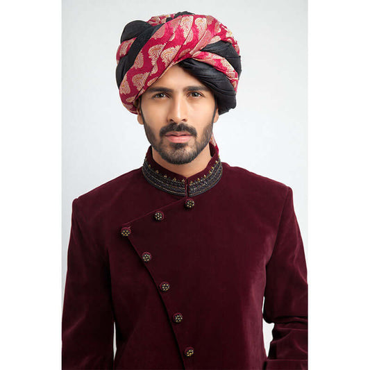 Close-up of Arsalan Iqbal maroon velvet sherwani with embroidered collar and pink paisley patterned turban.