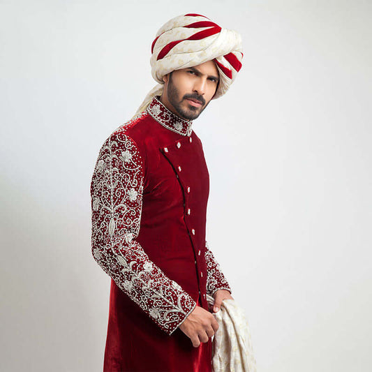 Burnt red velvet form-fitted sherwani featuring intricate detailing and a luxurious finish by Arsalan Iqbal, perfect for formal occasions.
