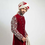 Burnt red velvet form-fitted sherwani featuring intricate detailing and a luxurious finish by Arsalan Iqbal, perfect for formal occasions.