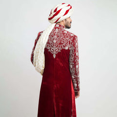 Burnt red velvet form-fitted sherwani featuring intricate detailing and a luxurious finish by Arsalan Iqbal, perfect for formal occasions.