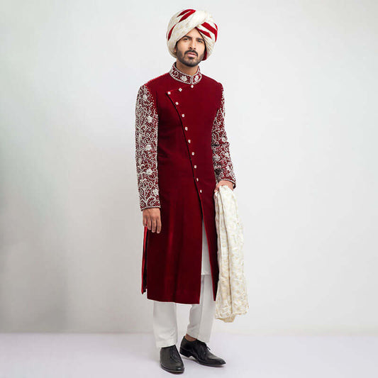 Burnt red velvet form-fitted sherwani featuring intricate detailing and a luxurious finish by Arsalan Iqbal, perfect for formal occasions.