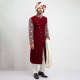 Burnt red velvet form-fitted sherwani featuring intricate detailing and a luxurious finish by Arsalan Iqbal, perfect for formal occasions.