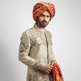 Ecru and grey brocade sherwani with a tailored fit, featuring intricate woven detailing for a regal, formal look.